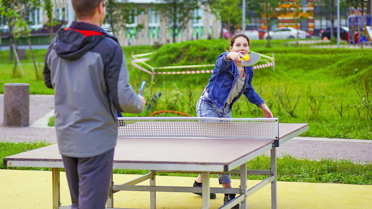 Teens playing outdoor ping pong game. Austin's food truck photos.